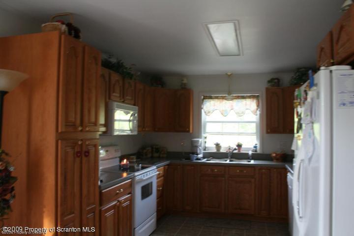 38 Zarychta Road Tunkhannock, PA 18657 - Photo 4 of 6 a kitchen with granite countertop a refrigerator stove and sink