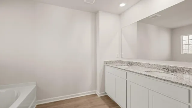 a utility room with granite countertop cabinets and sink