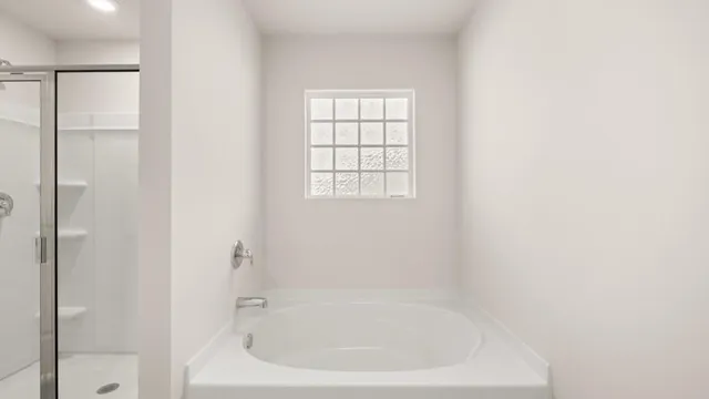 a white bath tub sitting next to a window