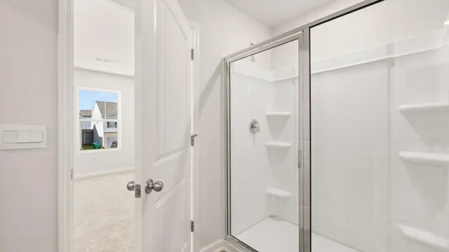 a bathroom with a glass shower door