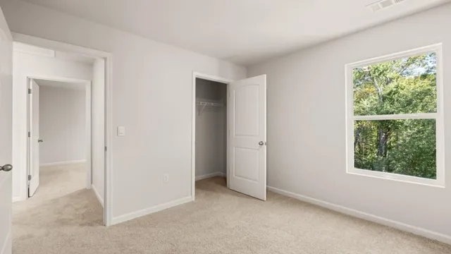 an empty room with windows and closet