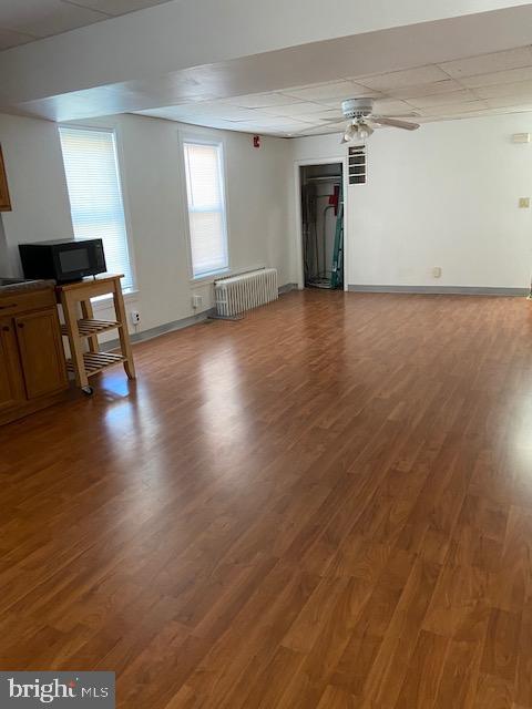 300 East Fort Avenue Baltimore, MD 21230 - Photo 3 of 14 an empty room with wooden floor and windows
