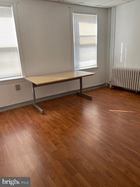 300 East Fort Avenue Baltimore, MD 21230 - Photo 6 of 14 an empty room with wooden floor and windows