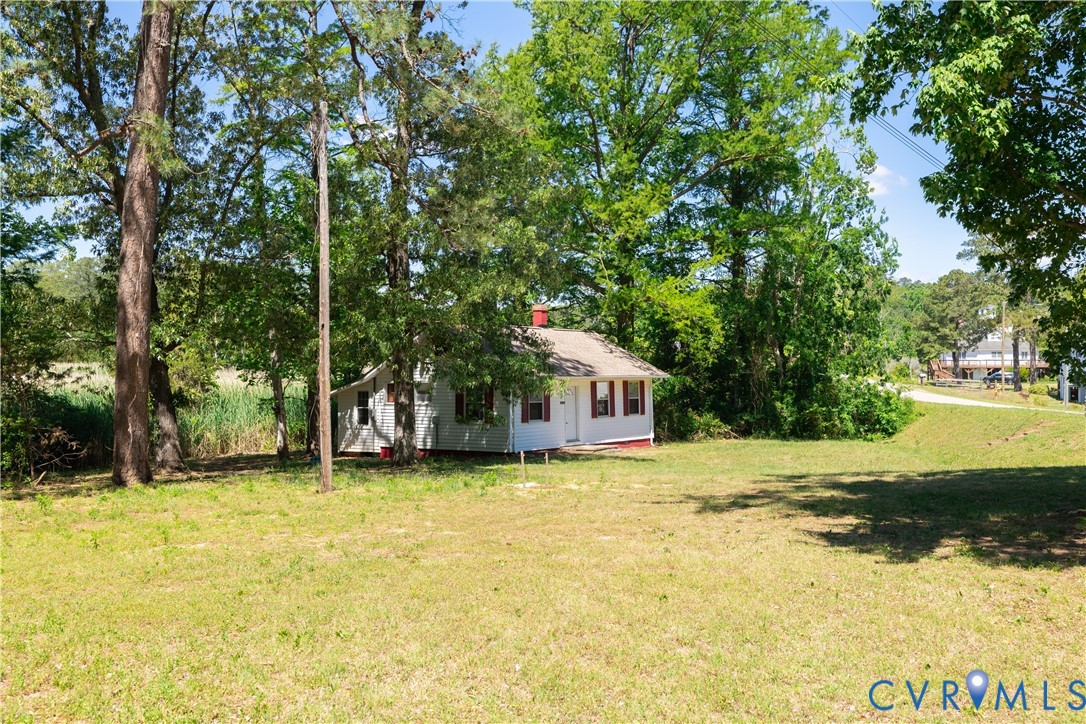 933 Pleasant Point Road Surry, VA 23883 - Photo 25 of 45 a house with trees in front of it