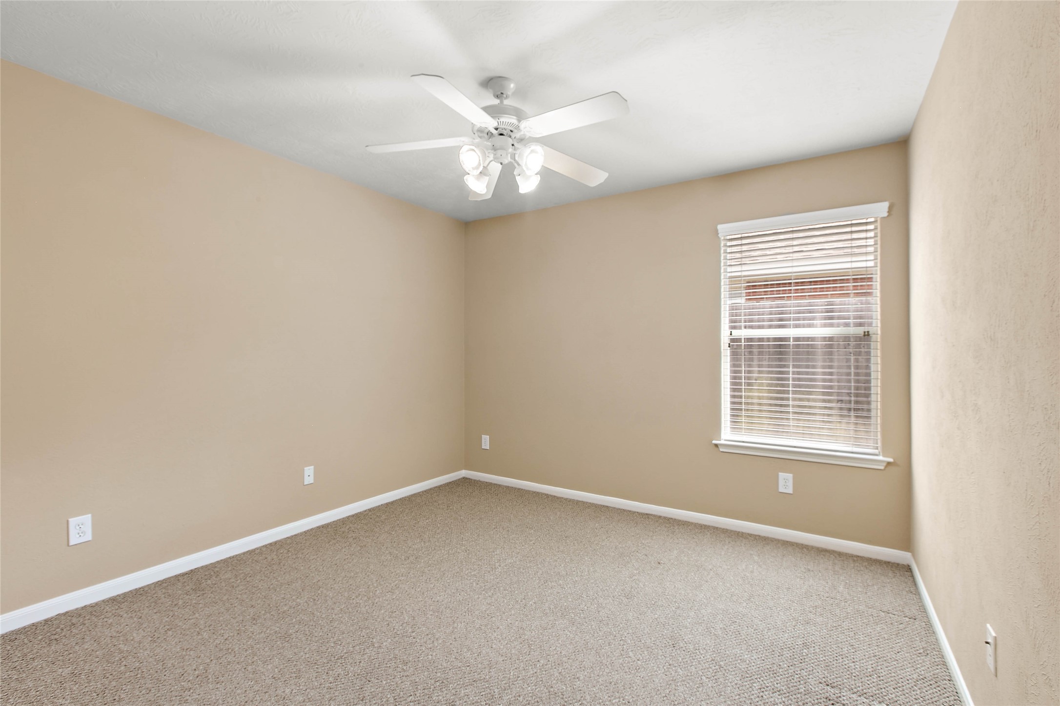 30411 Deleon Fields Drive Spring, TX 77386 - Photo 17 of 24 Cozy secondary bedroom complete with a ceiling fan for year-round comfort.