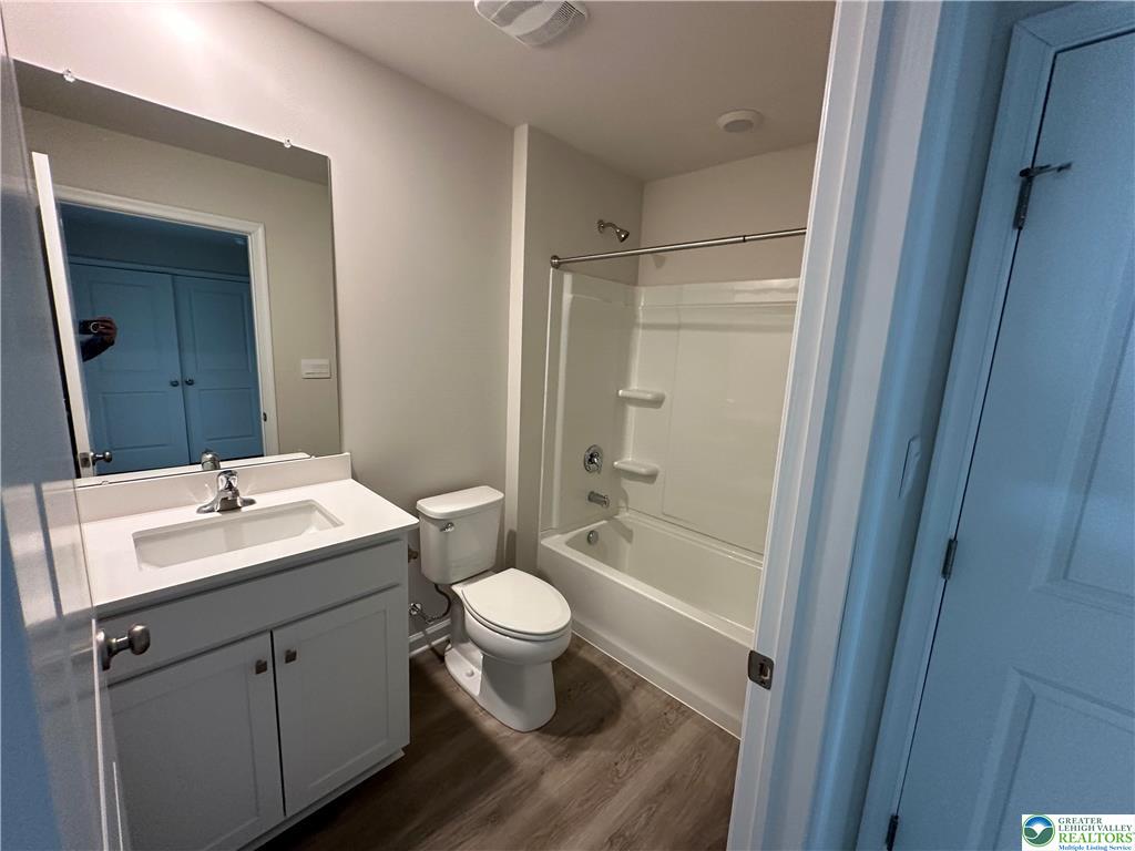 1145 Martin Road Breinigsville, PA 18031 - Photo 32 of 38 A well-appointed bath features a sleek vanity, modern toilet, and a pristine shower-tub combination.