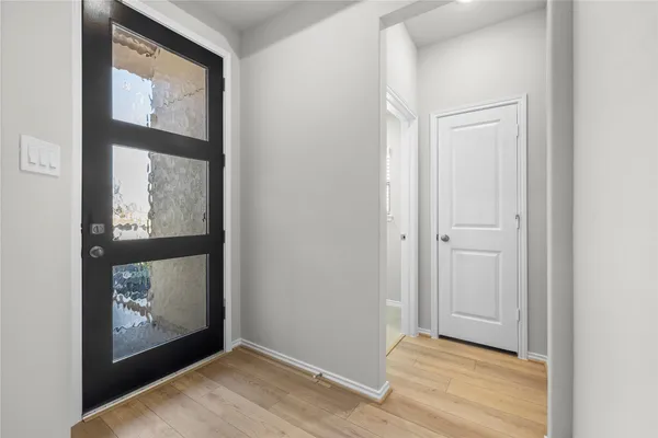 a view of an entryway with wooden floor