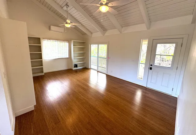 a view of a kitchen with wooden floor and staircase