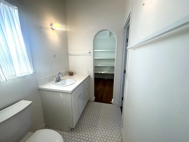 a view of walk in closet with empty racks