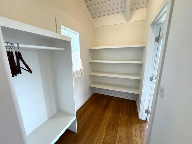 a view of an empty room and a window