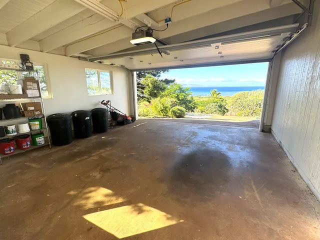 a view of a house with wooden deck and furniture