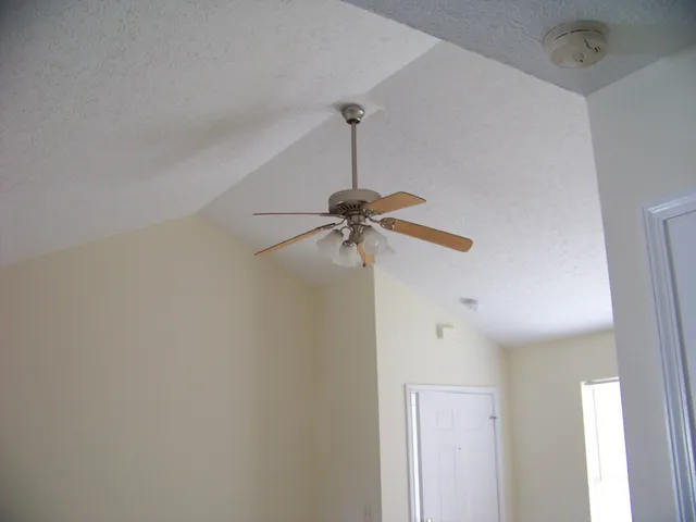 a bathroom with a shower and a ceiling fan
