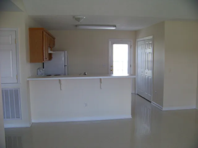 a view of a kitchen cabinets and a window