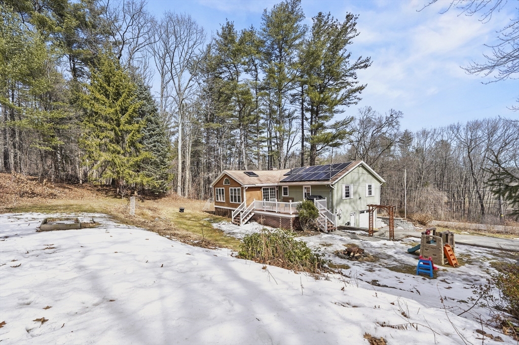 609 Langen Road Lancaster, MA 01523 - Photo 26 of 33 a view of a large house with large trees and wooden fence