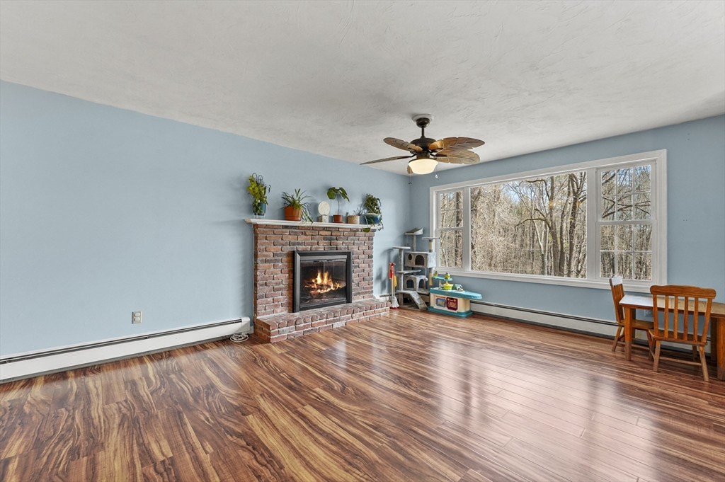 609 Langen Road Lancaster, MA 01523 - Photo 5 of 33 a view of an empty room with a window and wooden floor