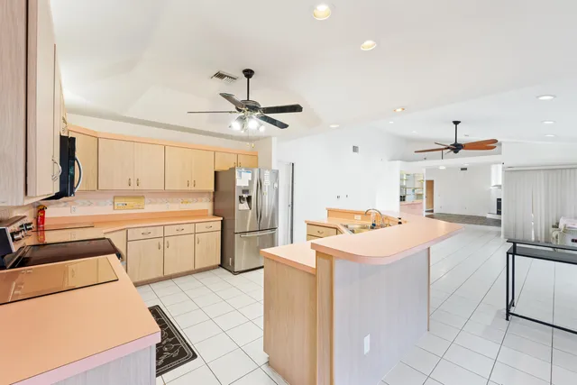 a kitchen that has a lot of cabinets in it and appliances
