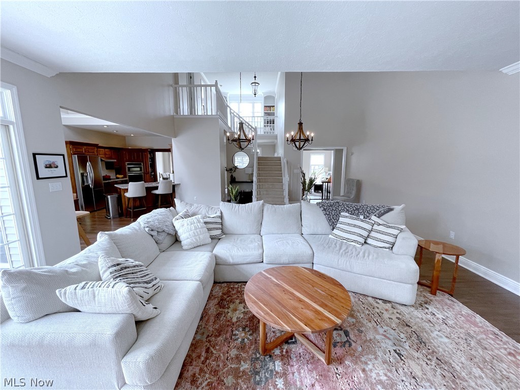 718 Sunridge Road Fairlawn, OH 44333 - Photo 9 of 49 Great room with a notable chandelier, dark wood-type flooring, and a towering ceiling