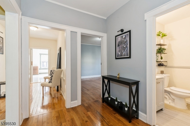 41 Poe Avenue Newark, NJ 07106 - Photo 18 of 44 a view of a hallway with bathroom and wooden floor