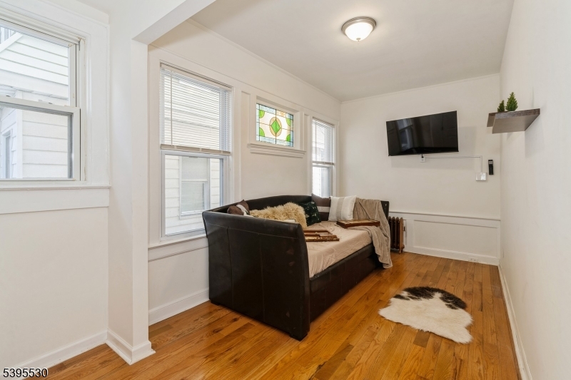 41 Poe Avenue Newark, NJ 07106 - Photo 20 of 44 a living room with furniture and a flat screen tv