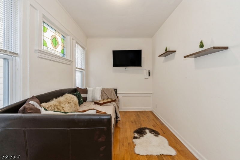 41 Poe Avenue Newark, NJ 07106 - Photo 30 of 44 a living room with furniture and a flat screen tv