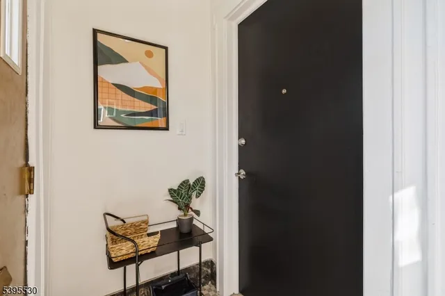a view of an empty room with a fireplace and a window