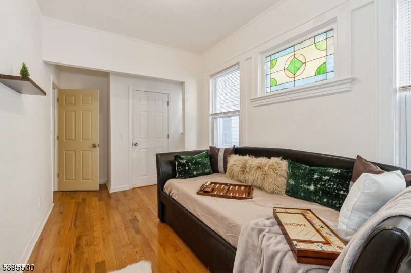 41 Poe Avenue Newark, NJ 07106 - Photo 31 of 44 a bedroom with a bed and wooden floor