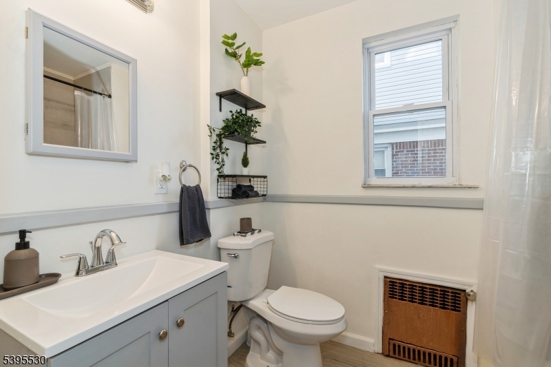 41 Poe Avenue Newark, NJ 07106 - Photo 32 of 44 a bathroom with a toilet sink and mirror