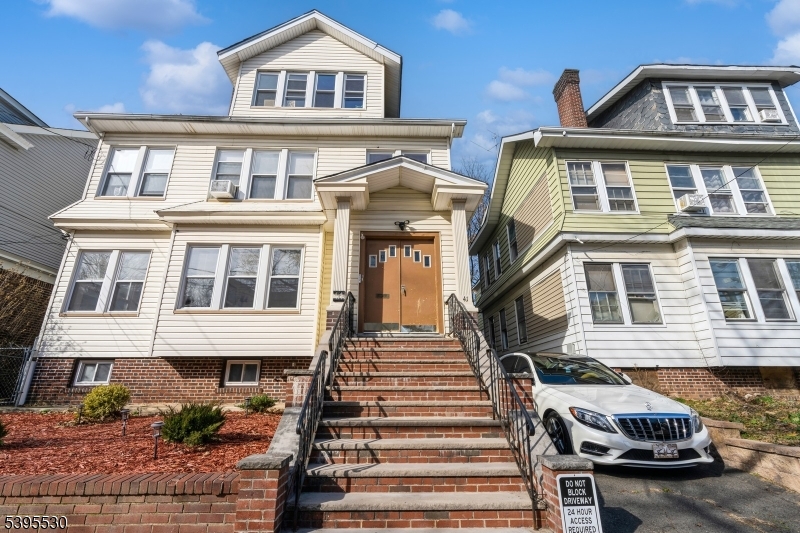 41 Poe Avenue Newark, NJ 07106 - Photo 33 of 44 a front view of a residential apartment building with a yard