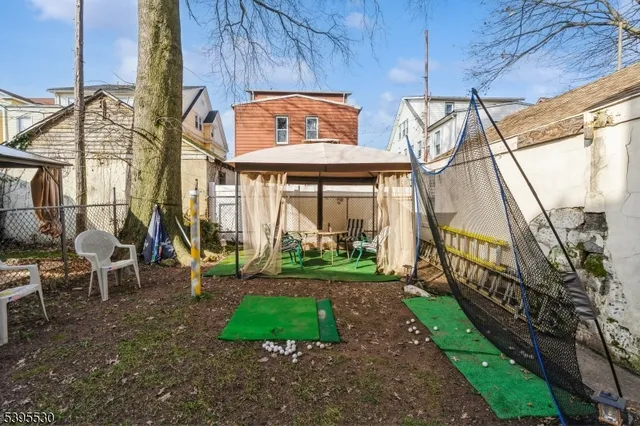 a view of a house with backyard and sitting area