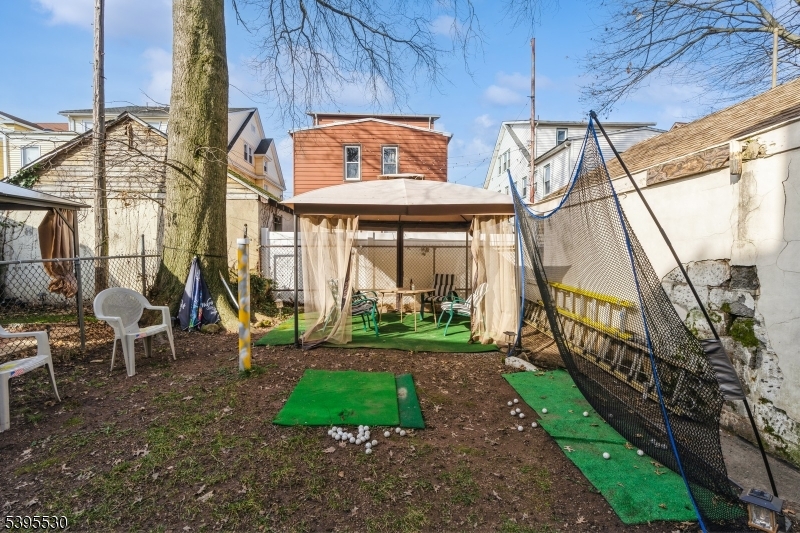 41 Poe Avenue Newark, NJ 07106 - Photo 39 of 44 a view of a house with a yard and sitting area