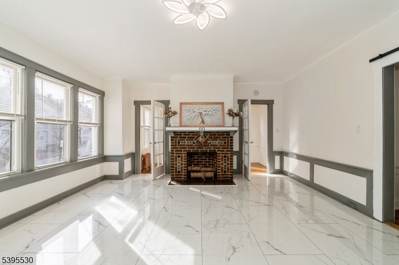 41 Poe Avenue Newark, NJ 07106 - Photo 6 of 44 a living room with furniture and a fireplace