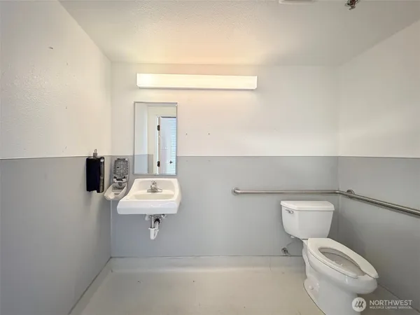 a view of an empty room with cabinet and a window