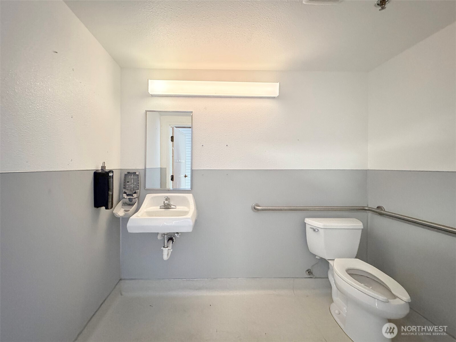 1400 West Washington Street, Unit 107 Sequim, WA 98382 - Photo 11 of 26 a bathroom with a toilet sink and mirror