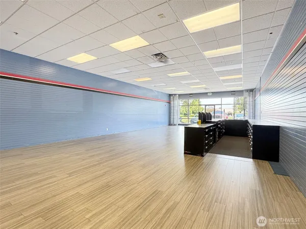 a view of a room with wooden floor