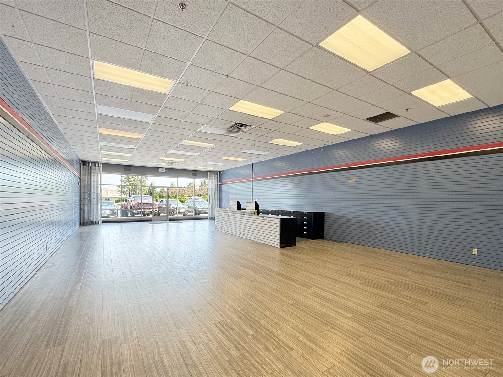 1400 West Washington Street, Unit 107 Sequim, WA 98382 - Photo 16 of 26 a view of a room with kitchen window and wooden floor
