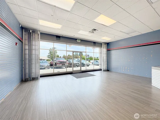 a view of a house with a large window and wooden fence