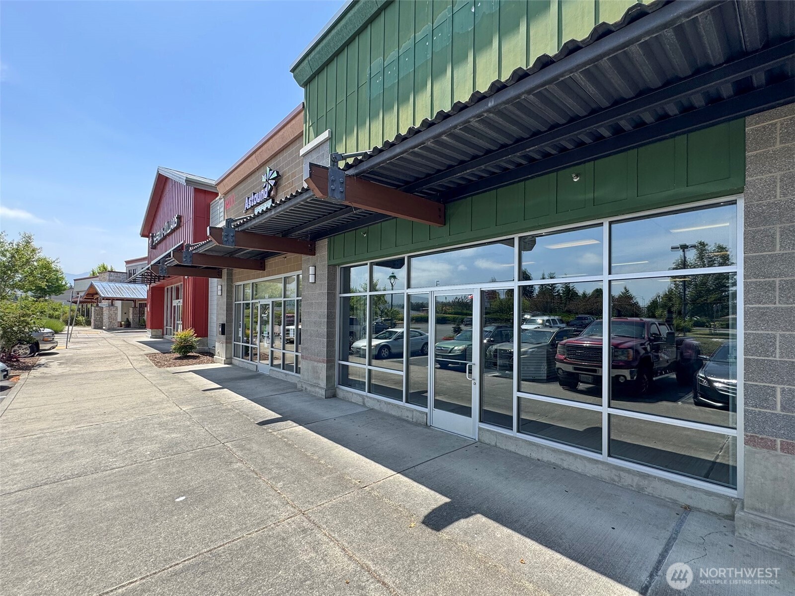 1400 West Washington Street, Unit 107 Sequim, WA 98382 - Photo 19 of 26 a view of a house with a large window and wooden fence