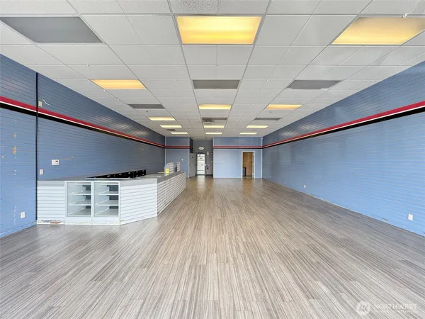a view of a room with wooden floor