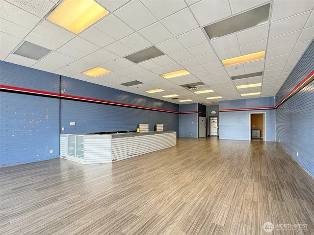 a view of a livingroom with an empty space and a window