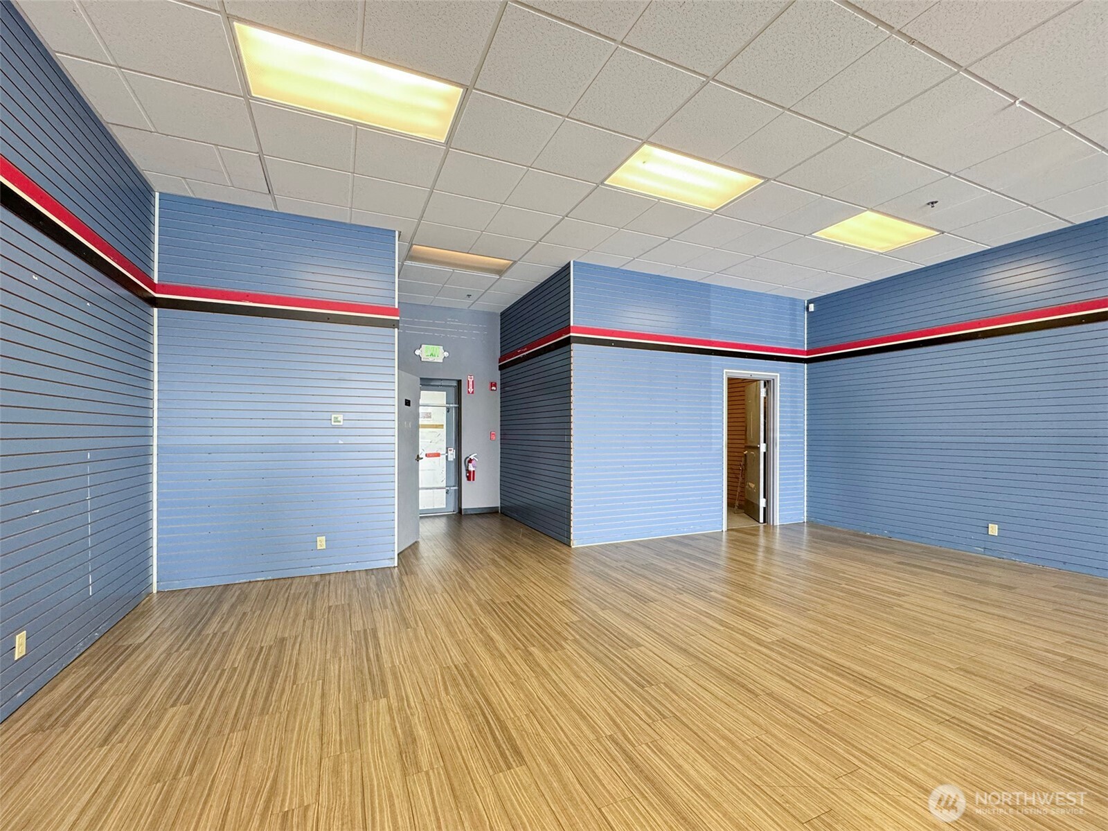 1400 West Washington Street, Unit 107 Sequim, WA 98382 - Photo 9 of 26 a view of an empty room with wooden floor