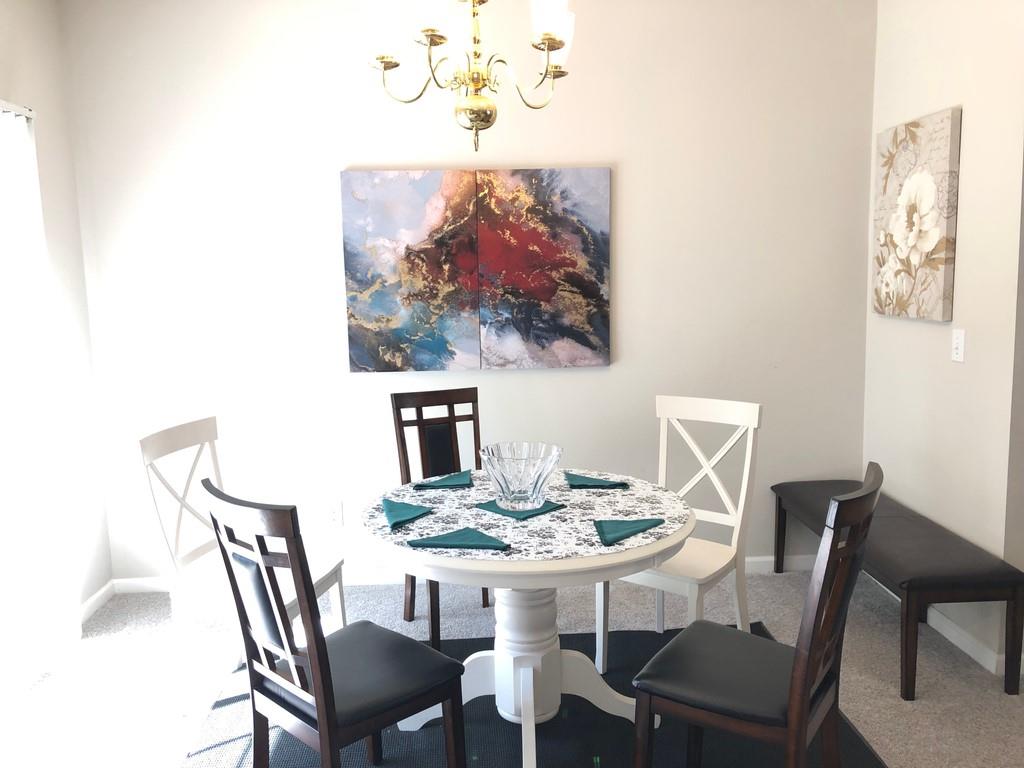 4171 Howell Park Road Duluth, GA 30096 - Photo 1 of 1 a view of a dining room with furniture and wooden floor
