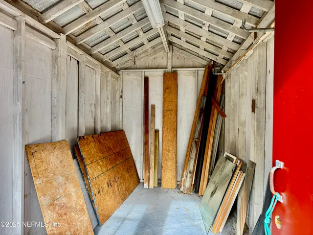 a bed sitting in a room next to a window