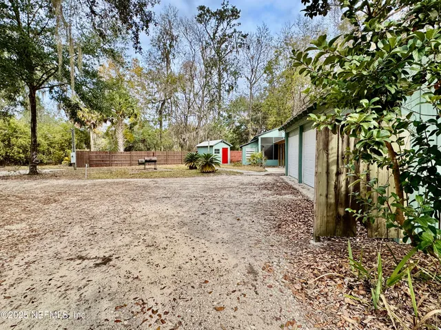 a backyard of a house with table and chairs