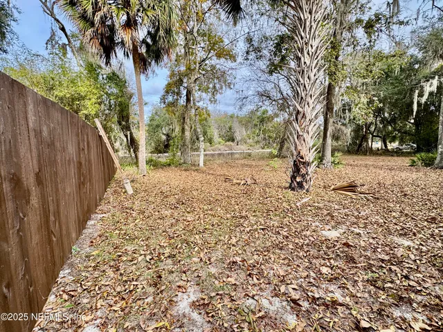 a view of a yard with trees