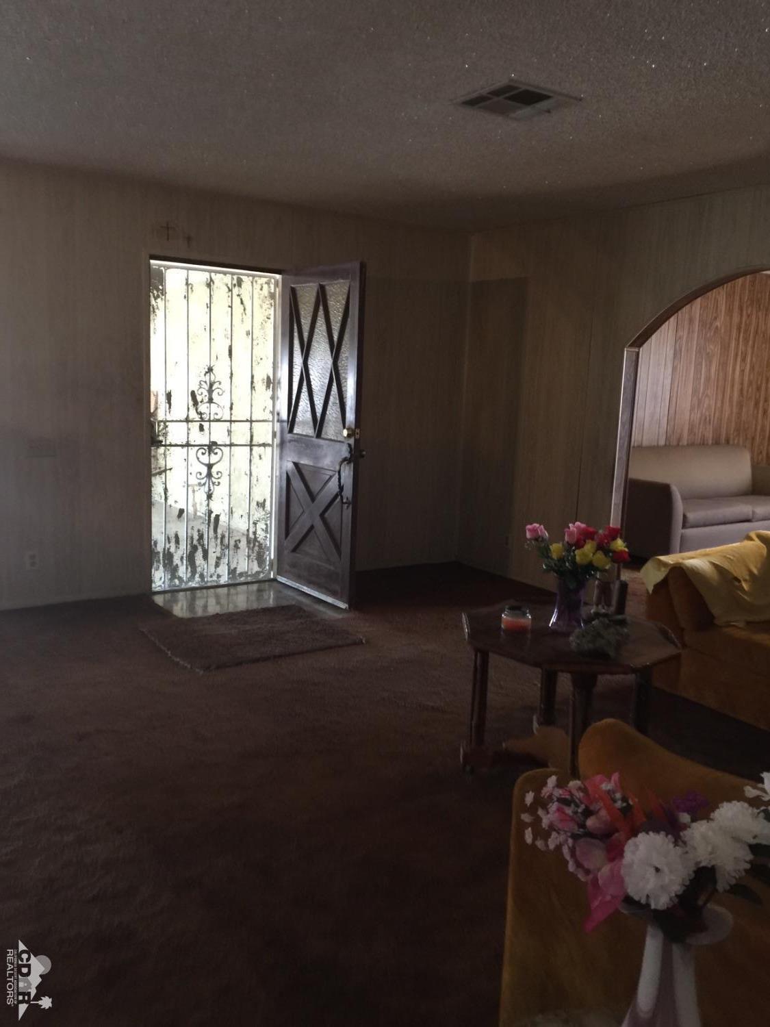46751 Arabia Street Indio, CA 92201 - Photo 13 of 42 a living room with furniture window and wooden floor