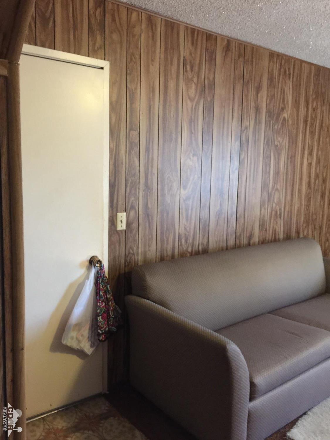 46751 Arabia Street Indio, CA 92201 - Photo 18 of 42 a living room with furniture and a gate