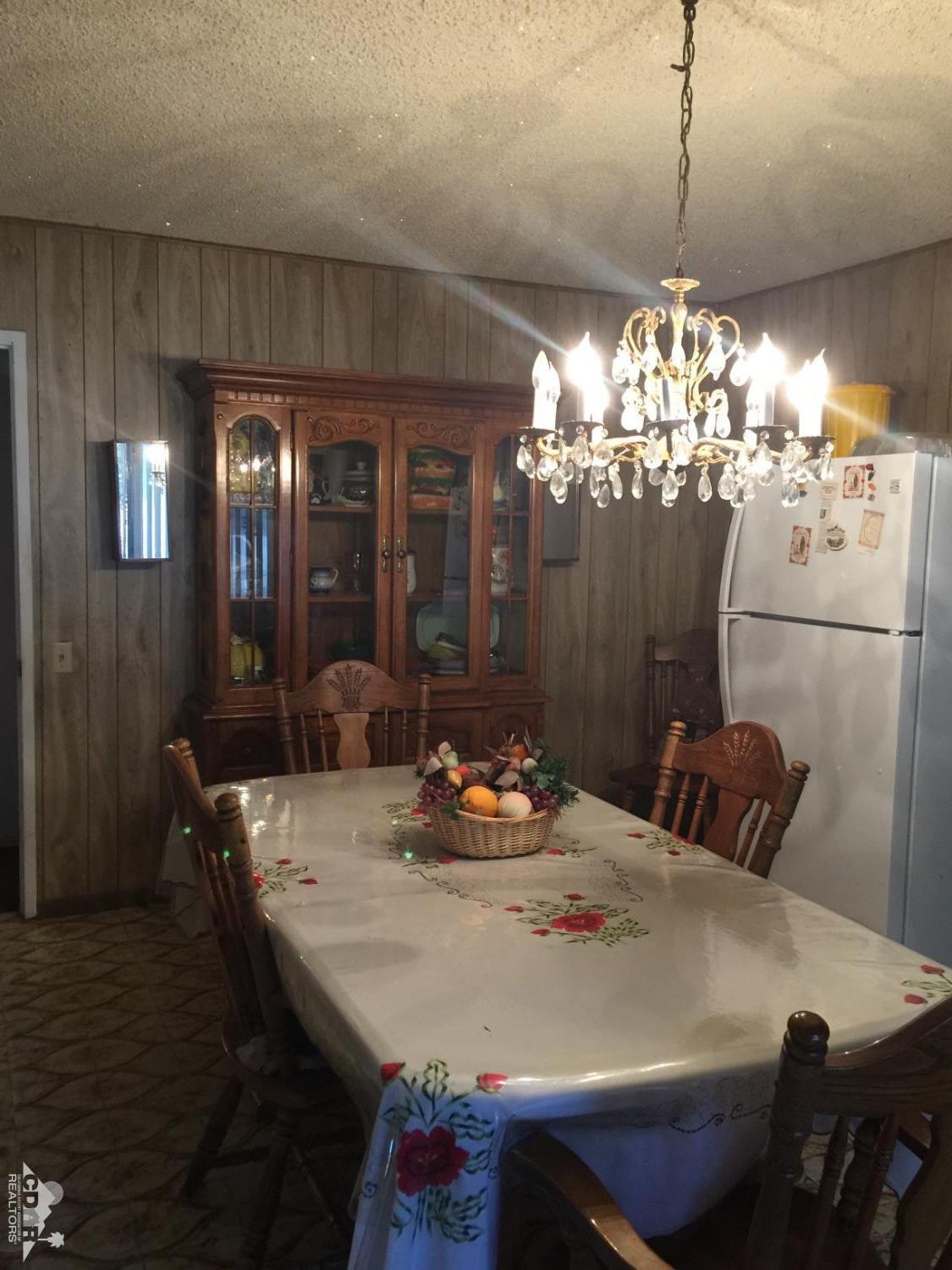 46751 Arabia Street Indio, CA 92201 - Photo 23 of 42 a dining room with furniture and chandelier kitchen view