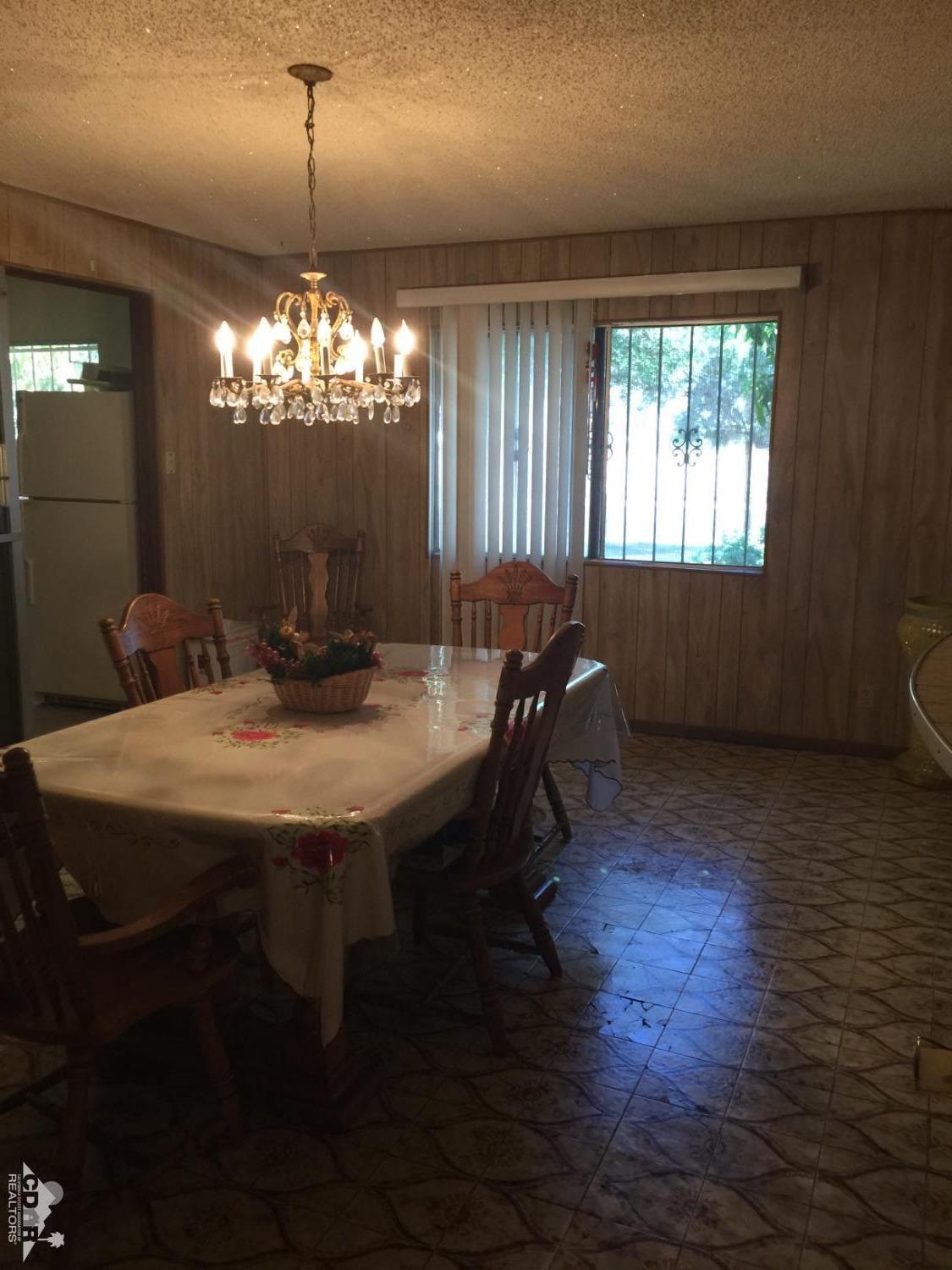 46751 Arabia Street Indio, CA 92201 - Photo 25 of 42 a view of a dining room with furniture window and wooden floor