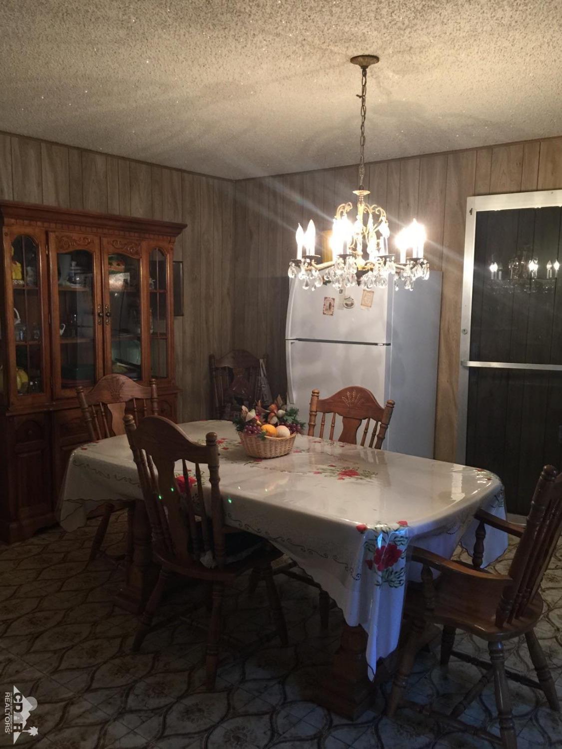 46751 Arabia Street Indio, CA 92201 - Photo 26 of 42 a view of a dining room with furniture and chandelier