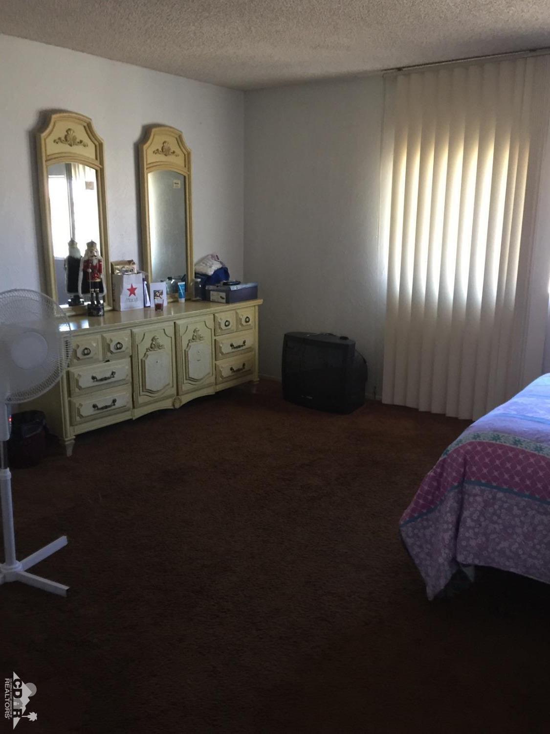 46751 Arabia Street Indio, CA 92201 - Photo 34 of 42 a living room with furniture and a windows